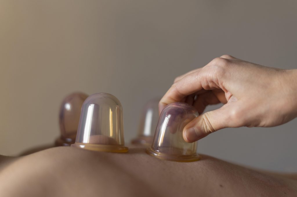 close-up-hand-holding-cup TCM Cupping Page